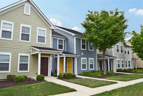 Pilesgrove apartment for rent - a row of townhomes with a tree in front of them