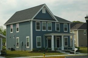 Pleasantville apartment for rent - a blue house with a yellow fire hydrant in front of it