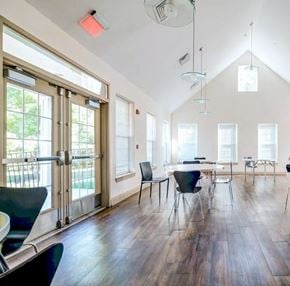 Elkridge apartment for rent - a dining room with a table and chairs and large windows