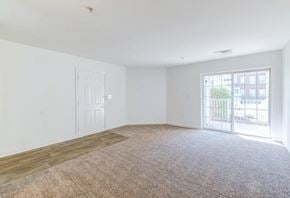 Elkridge apartment for rent - an empty living room with a door to a balcony