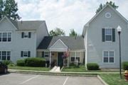 Landing townhouse for rent - a white house with a flag in front of it