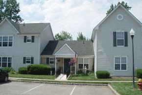 Landing townhouse for rent - a white house with a flag in front of it