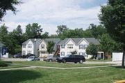 Landing townhouse for rent - a group of cars parked in front of houses