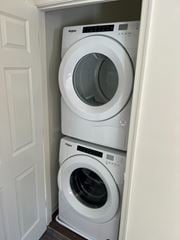 Salisbury apartment for rent - Two white washing machines stacked in a small space.
