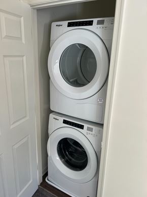 Salisbury apartment for rent - Two white washing machines stacked in a small space.