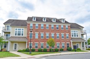 Williamstown apartment for rent - A red brick building with a black lamppost in front.