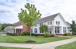 Williamstown apartment for rent - A white house with a red brick chimney and a tree in front.