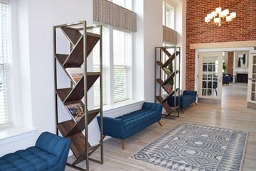 Williamstown apartment for rent - A living room with a blue couch and a bookshelf.