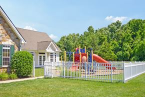 Mullica Hill apartment for rent - a playground in front of a house behind a white fence