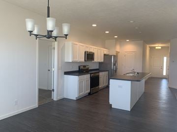Lafayette apartment for rent - a kitchen with white cabinets and black counter tops