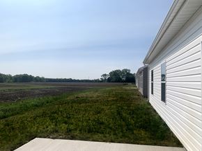 Lafayette apartment for rent - a view of the side of a white building overlooking a field