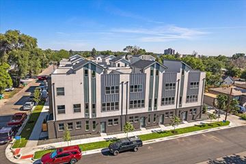Lakewood apartment for rent - an aerial view of a building with cars parked in front of it