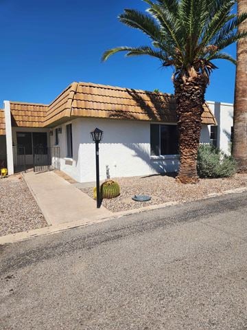 Tucson house for rent - a house with a palm tree in front of it