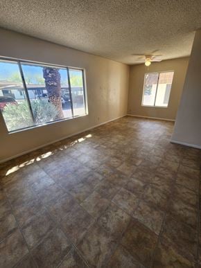 Tucson house for rent - an empty living room with a large window