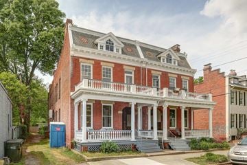 Richmond apartment for rent - a red brick house with a white porch and a blue mailbox