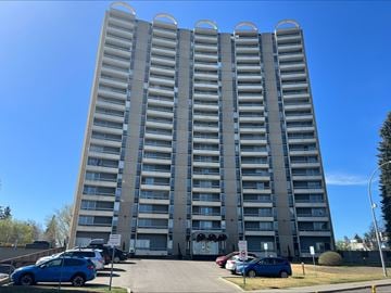 Edmonton house for rent - a tall building with cars parked in front of it