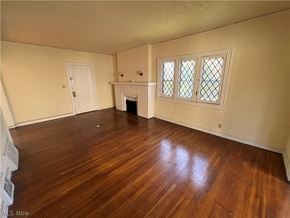 Shaker Heights apartment for rent - an empty living room with wood floors and a fireplace