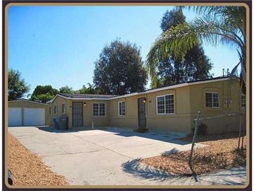 Vista apartment for rent - a yellow house with a palm tree in front of it