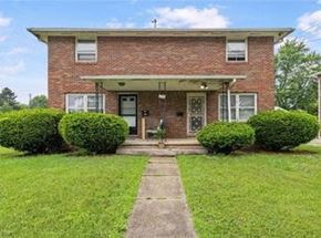 Canton apartment for rent - A brick house with a white door and windows.
