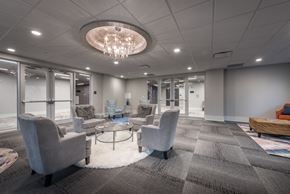 Gretna apartment for rent - a lobby with couches chairs and tables and a chandelier