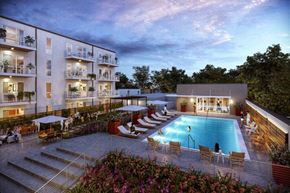 Gretna apartment for rent - a swimming pool in front of a hotel at dusk