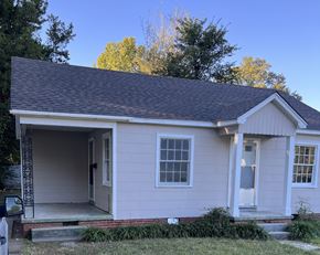 Clarksdale house for rent - the front of a white house with a porch
