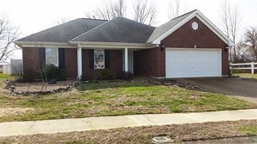 Owensboro house for rent - a brick house with a white garage door