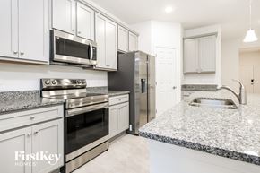 Kissimmee house for rent - a kitchen with granite counter tops and stainless steel appliances