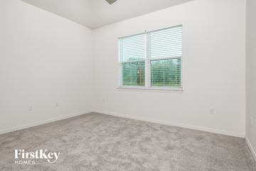 Kissimmee house for rent - the living room of a home with carpet and a window