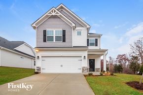 Greenville house for rent - a white and gray house with a garage door