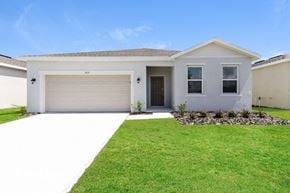 Bartow house for rent - A white house with a garage door and windows.