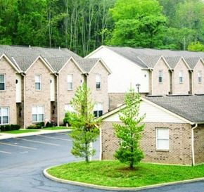 Cleves apartment for rent - an empty parking lot in front of a row of houses