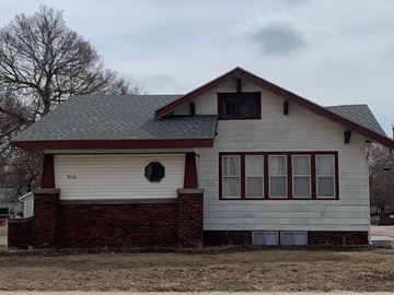 Kearney apartment for rent - a white house with a brick wall and a gray roof