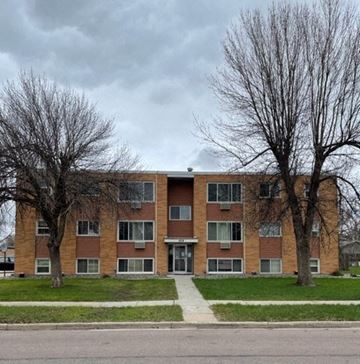 Fargo apartment for rent - a brick apartment building with two trees in front of it