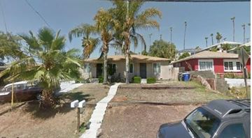 Vista apartment for rent - a house with palm trees and a car parked in front of it