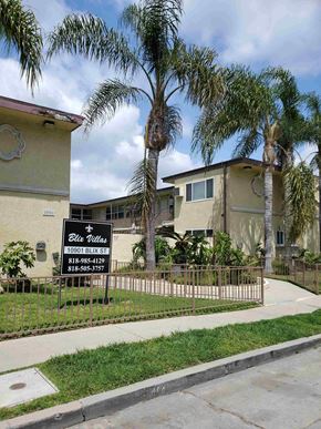 N. Hollywood apartment for rent - a house with palm trees and a sign in front of it