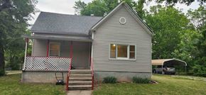 Windsor house for rent - A small house with a grey roof and a red and white porch.