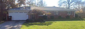 Cincinnati house for rent - a red brick house with a white garage door