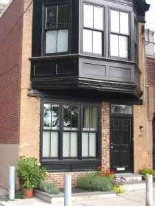 Philadelphia apartment for rent - A black and white building with a black door and windows.