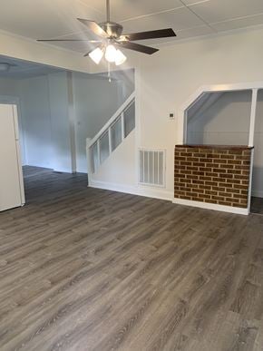 Lindale apartment for rent - an empty living room with wood floors and a ceiling fan