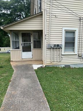 Lindale apartment for rent - a front porch of a house with a walkway and grass
