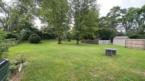 Cincinnati house for rent - a backyard with a yard and trees and a wooden fence