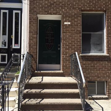 Philadelphia apartment for rent - a red brick building with a black door and stairs