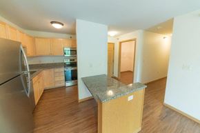 Owatonna apartment for rent - an empty kitchen with a granite counter top
