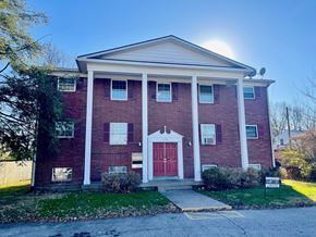Clarksville apartment for rent - A red brick house with a white door and windows.