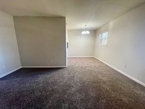 Clarksville apartment for rent - A room with a carpeted floor and a window.