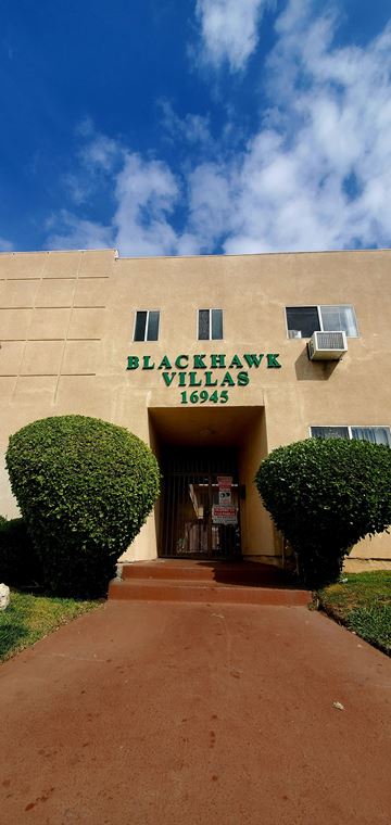 Granada Hills apartment for rent - a large building with a sign on the front of it