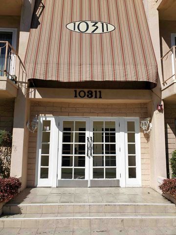 Toluca Lake apartment for rent - a striped awning over the front door of a building