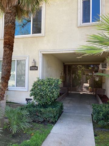 West Toluca Lake apartment for rent - the front of a house with a walkway and palm trees