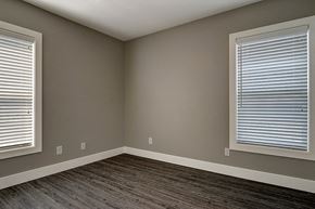 Seattle apartment for rent - an empty room with wood floors and two windows